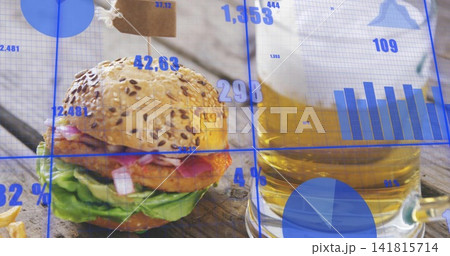 Displaying seeded burger with paper tag sitting on wooden table, with beer mug, fries, data overlay Displaying seeded burger with paper tag sitting on wooden table, with beer mug, fries, data overlay 141815714