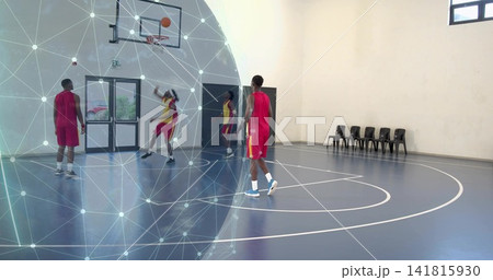Shooting basketball player with team in red jerseys training in gym by hoop, with network graphic Shooting basketball player with team in red jerseys training in gym by hoop, with network graphic 141815930
