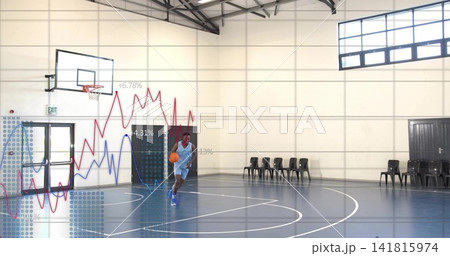 Dribbling basketball player moving across gym in blue jersey, with orange ball and data overlays Dribbling basketball player moving across gym in blue jersey, with orange ball and data overlays 141815974