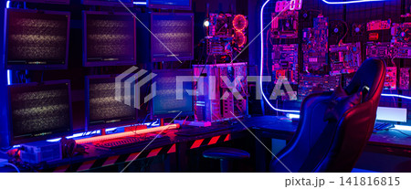 A computer room with a neon blue wall and neon green and purple lights A computer room with a neon blue wall and neon green and purple lights 141816815