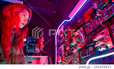 Asian woman wearing a black jacket hacking programming system check hacking hardware circuit in dark office, Cyber security agency developing, Computer electronics 141816833