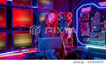 Asian woman is sitting at a desk with a laptop service in server room, Thinking and solve problems, Software engineer typing coding in laptop computer at data center Asian woman is sitting at a desk with a laptop service in server room, Thinking and solve problems, Software engineer typing coding in laptop computer at data center 141816839