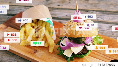 Showing sesame burger posing on rustic board at cafe, with paper cone fries, skewer, social icons 141817053