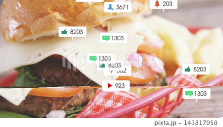 Showing cheeseburger with sesame bun and melted white cheese in red basket, fries and notifications Showing cheeseburger with sesame bun and melted white cheese in red basket, fries and notifications 141817058