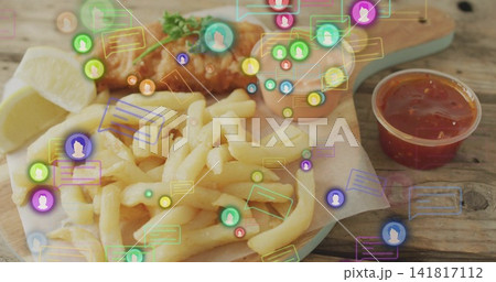 Showing pile of fries with fried fish, lemon wedge and sauces on wooden board, featuring overlays 141817112