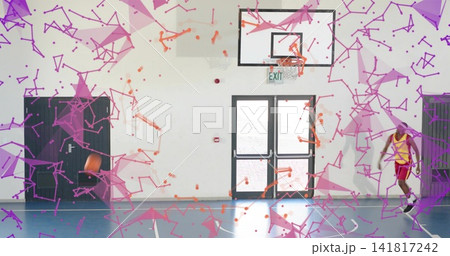 Dribbling player in yellow jersey and red shorts on gym court, basketball moving, copy space Dribbling player in yellow jersey and red shorts on gym court, basketball moving, copy space 141817242