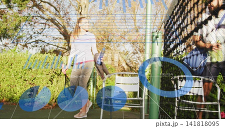 Standing fit woman in athletic wear holding reusable bottle and towel near court fence, copy space Standing fit woman in athletic wear holding reusable bottle and towel near court fence, copy space 141818095