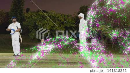 Standing batter in white kit holding bat at crease on floodlit pitch, magenta lights, copy space Standing batter in white kit holding bat at crease on floodlit pitch, magenta lights, copy space 141818251
