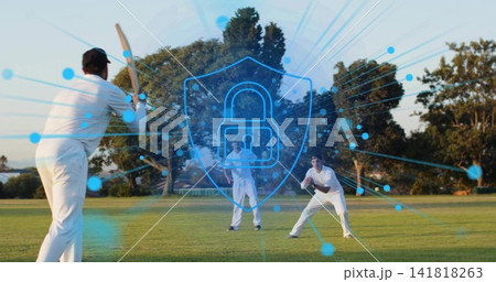 Batting batter holding wooden bat with team in whites at local field, showing blue padlock overlay Batting batter holding wooden bat with team in whites at local field, showing blue padlock overlay 141818263