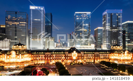 Night view of Tokyo Station. It's a major inter-city rail terminal in Chiyoda, Tokyo, Japan, with the Marunouchi and Yaesu high-rise business buildings in view.  141818459