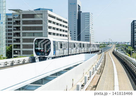 View of a New Transit Yurikamome line train running on the elevated track in Koto, Tokyo, Japan. It's an automated guideway transit service in Tokyo. View of a New Transit Yurikamome line train running on the elevated track in Koto, Tokyo, Japan. It's an automated guideway transit service in Tokyo. 141818466