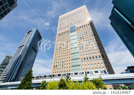 Tokyo, Japan- August 4, 2025: Low-angle view of a New Transit Yurikamome line train running on the elevated track with modern skyscrapers in Shiodome, Minato, Tokyo, Japan. It's an automated guideway Tokyo, Japan- August 4, 2025: Low-angle view of a New Transit Yurikamome line train running on the elevated track with modern skyscrapers in Shiodome, Minato, Tokyo, Japan. It's an automated guideway 141818467