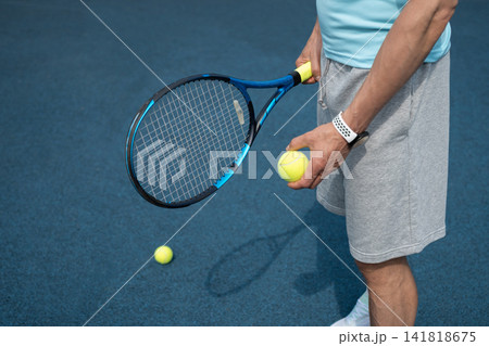 Holding tennis racket and ball before practice Holding tennis racket and ball before practice 141818675