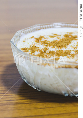 Homemade Spanish Rice Pudding with Cinnamon on Wooden Table 141818708