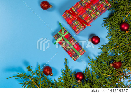 Christmas gifts and ornaments on blue background Christmas gifts and ornaments on blue background 141819587