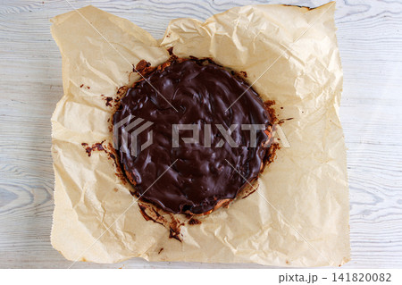 Top view of whole homemade almond brownie on parchment paper Top view of whole homemade almond brownie on parchment paper 141820082