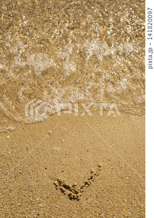Heart shape drawn in wet sand at beach shore Heart shape drawn in wet sand at beach shore 141820097