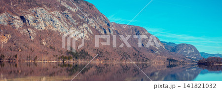 Rocky shore of the mountain lake. Beautiful nature. Reflection on the lake Rocky shore of the mountain lake. Beautiful nature. Reflection on the lake 141821032