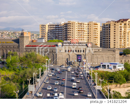 Busy city street with historic stone archway and modern apartments Busy city street with historic stone archway and modern apartments 141821204