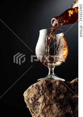 Cognac resting on a piece of natural granite rock. 141821465
