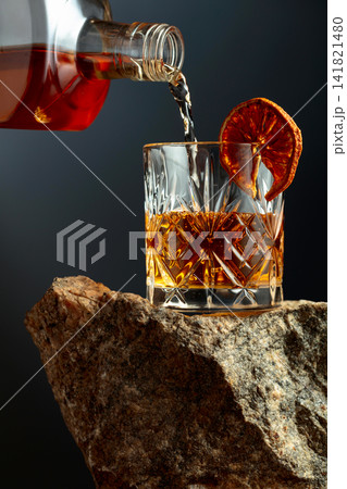 Old-fashoned cocktail on a rough granite. 141821480
