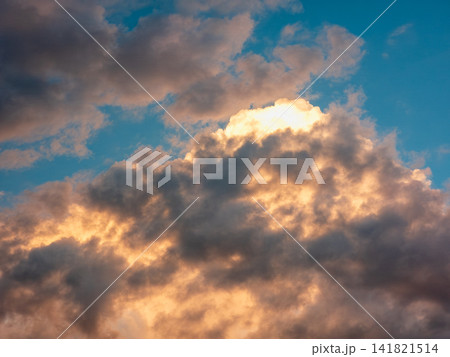 Dramatic sky scene with glowing clouds illuminated by sunrise or sunset Dramatic sky scene with glowing clouds illuminated by sunrise or sunset 141821514