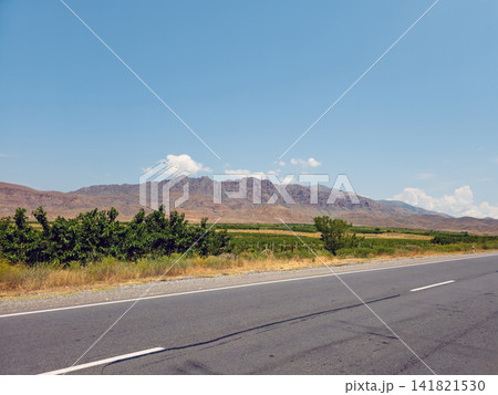 Desert highway stretches toward distant mountains Desert highway stretches toward distant mountains 141821530