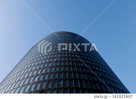 Low angle view of modern glass skyscraper corporate building. Low angle view of modern glass skyscraper corporate building. 141821697