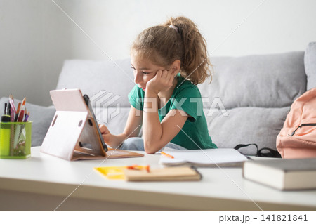 Girl studying with tablet at home Girl studying with tablet at home 141821841