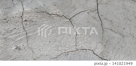 Cracks on the concrete surface are light gray in color Cracks on the concrete surface are light gray in color 141821949