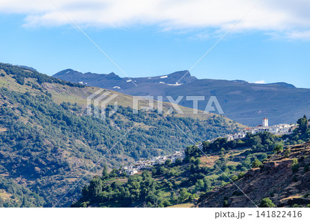 Picturesque view of a village Pampaneira located on a mountainside in the Sierra Nevada region of Spain 141822416