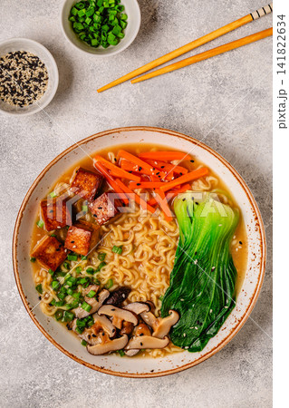 Noodles ramen miso soup served with tofu, bok choy, carrots, and mushrooms. Noodles ramen miso soup served with tofu, bok choy, carrots, and mushrooms. 141822634