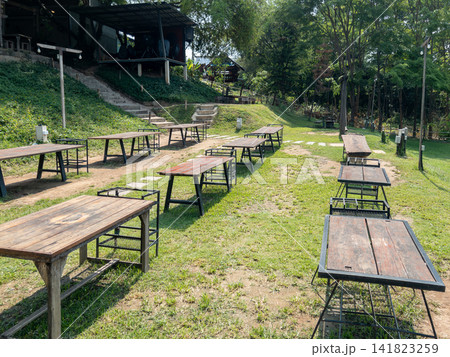 Outdoor Garden Cafe Seating Area with Wooden Tables Outdoor Garden Cafe Seating Area with Wooden Tables 141823259