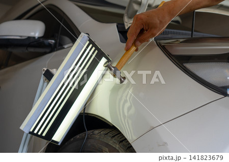 Removing dents on the car. PDR technology. Car body repair without painting. Removing dents on the car. PDR technology. Car body repair without painting. 141823679