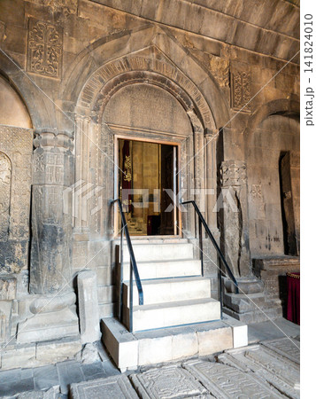 Stone entrance with arched doorway and steps 141824010