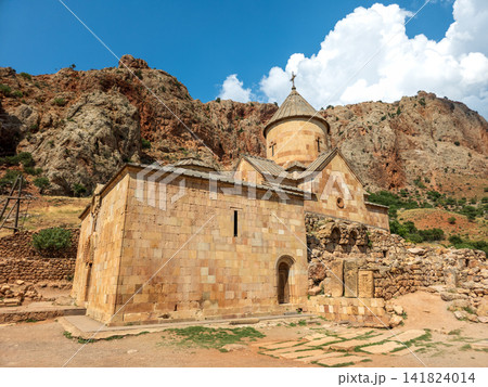 Mountain Noravank Monastery with stone architecture against rocky backdrop 141824014