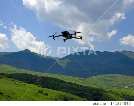 Aerial view of drone capturing landscape of rolling green hills Aerial view of drone capturing landscape of rolling green hills 141824049