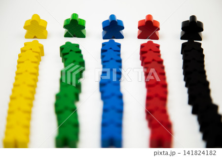 Side view of rows of wooden multi-colored men, with a large man at the base, divided into teams on a white background. The concept of team competitions, community groups, people. High quality photo Side view of rows of wooden multi-colored men, with a large man at the base, divided into teams on a white background. The concept of team competitions, community groups, people. High quality photo 141824182