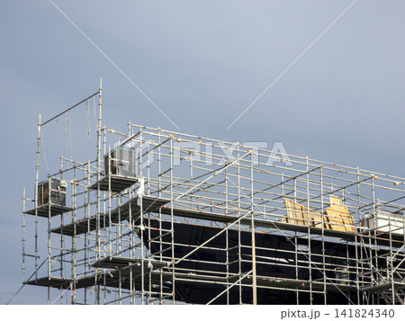 Scaffolding around yacht hull for maintenance work in shipyard 141824340