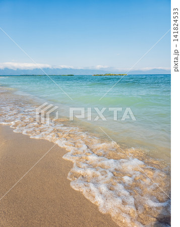 Calm tropical shoreline, turquoise water meets golden sand, peaceful horizon Calm tropical shoreline, turquoise water meets golden sand, peaceful horizon 141824533