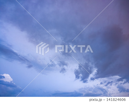 Dramatic blue and purple sky with drifting clouds Dramatic blue and purple sky with drifting clouds 141824606