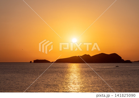 Sa Conillera near Platges de Comte, centered sun high above the island and straight reflection. 141825090