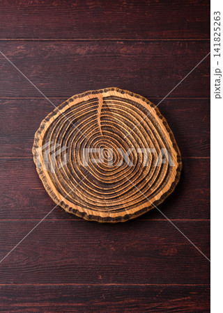 A square wooden cutting board for home food preparation. A wooden cutting board 141825263