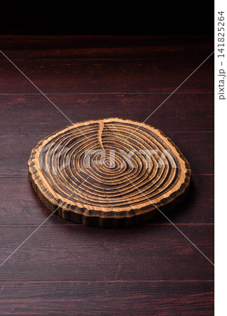 A square wooden cutting board for home food preparation. A wooden cutting board 141825264