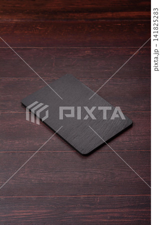 An empty black slate kitchen board for food preparation. An empty slate board serving An empty black slate kitchen board for food preparation. An empty slate board serving 141825283