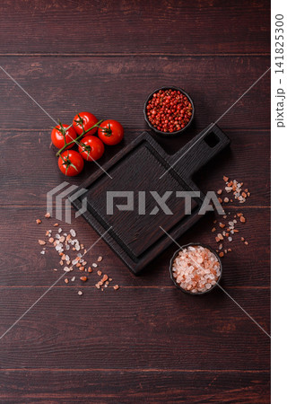 A square wooden cutting board for home food preparation. A wooden cutting board A square wooden cutting board for home food preparation. A wooden cutting board 141825300