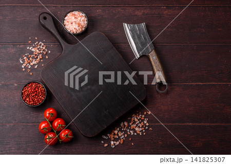 A square wooden cutting board for home food preparation. A wooden cutting board A square wooden cutting board for home food preparation. A wooden cutting board 141825307