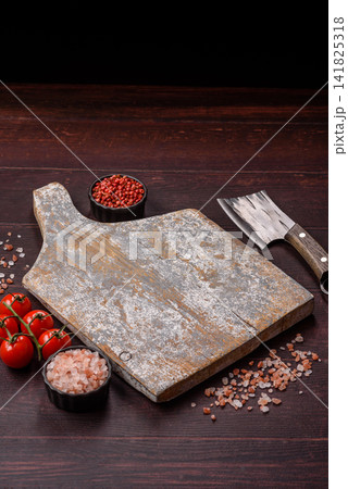 A square wooden cutting board for home food preparation. A wooden cutting board A square wooden cutting board for home food preparation. A wooden cutting board 141825318