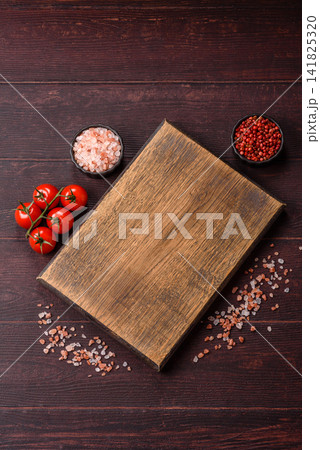 A square wooden cutting board for home food preparation. A wooden cutting board 141825320