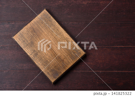A square wooden cutting board for home food preparation. A wooden cutting board A square wooden cutting board for home food preparation. A wooden cutting board 141825322